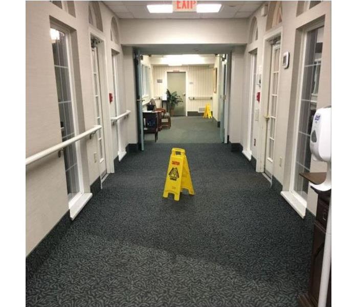 water on carpet in hallway