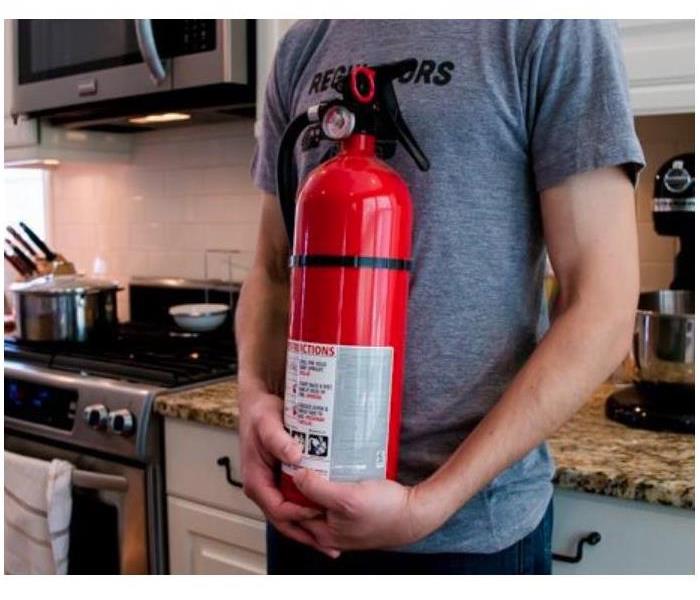 person holding fire extinguisher