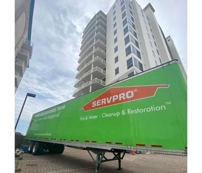 servpro trailer outside hurricane damaged building